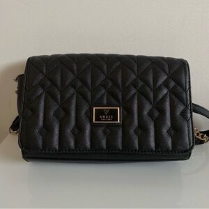 Guess purse with shoulder strap.  Black in colour.  Overall in nice condition